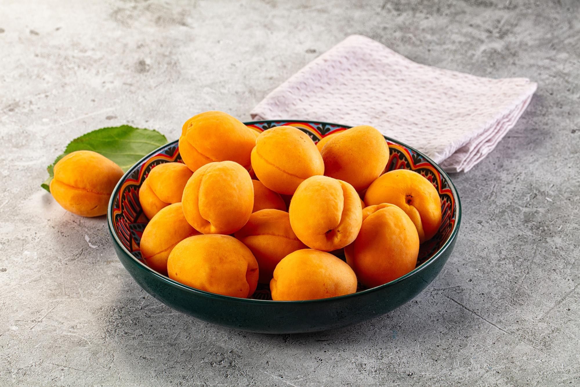 Ripe apricots in a painted bowl
