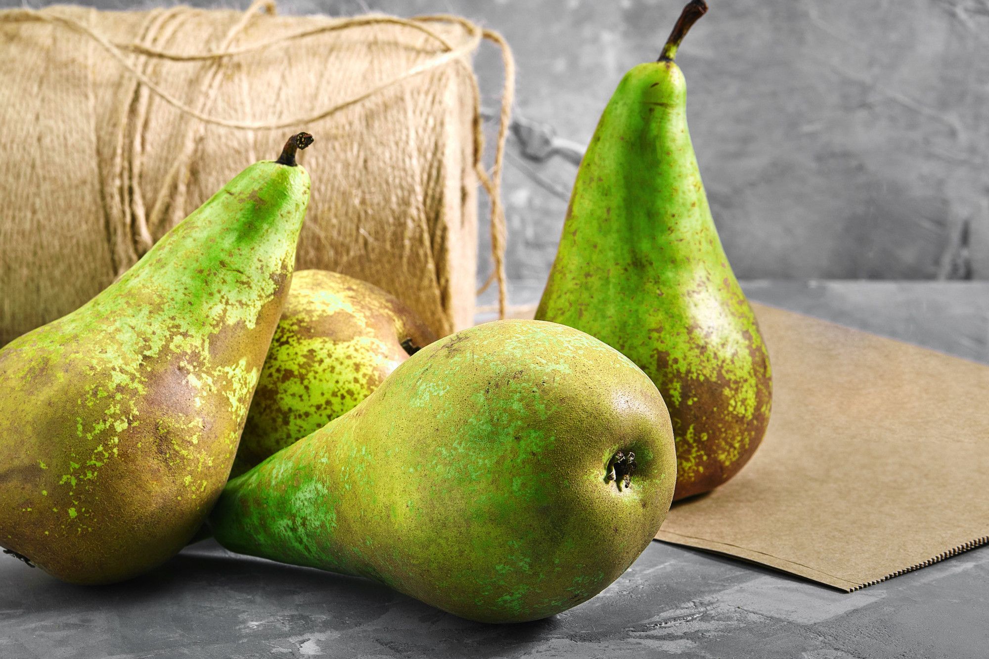 Ripe green pears on a stone table